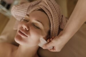 Client receiving a relaxing hands-on facial treatment in Suffolk