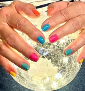 5x multicoloured nails on a light globe